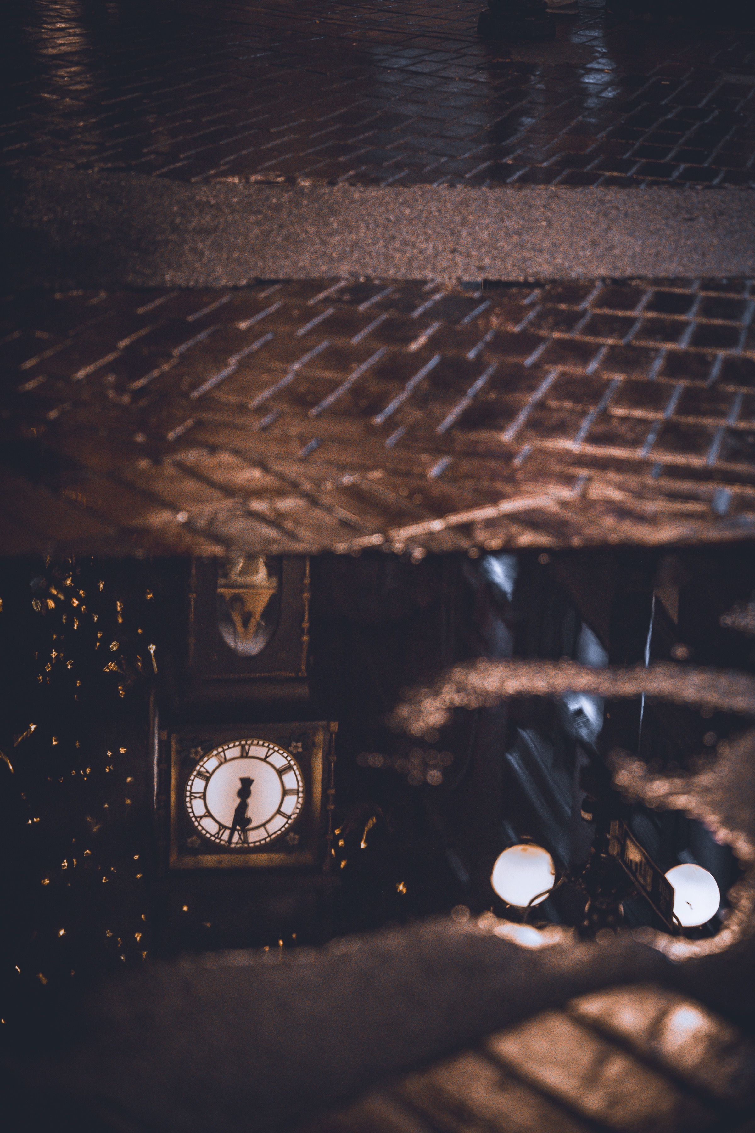 Dim clock and street reflection at night