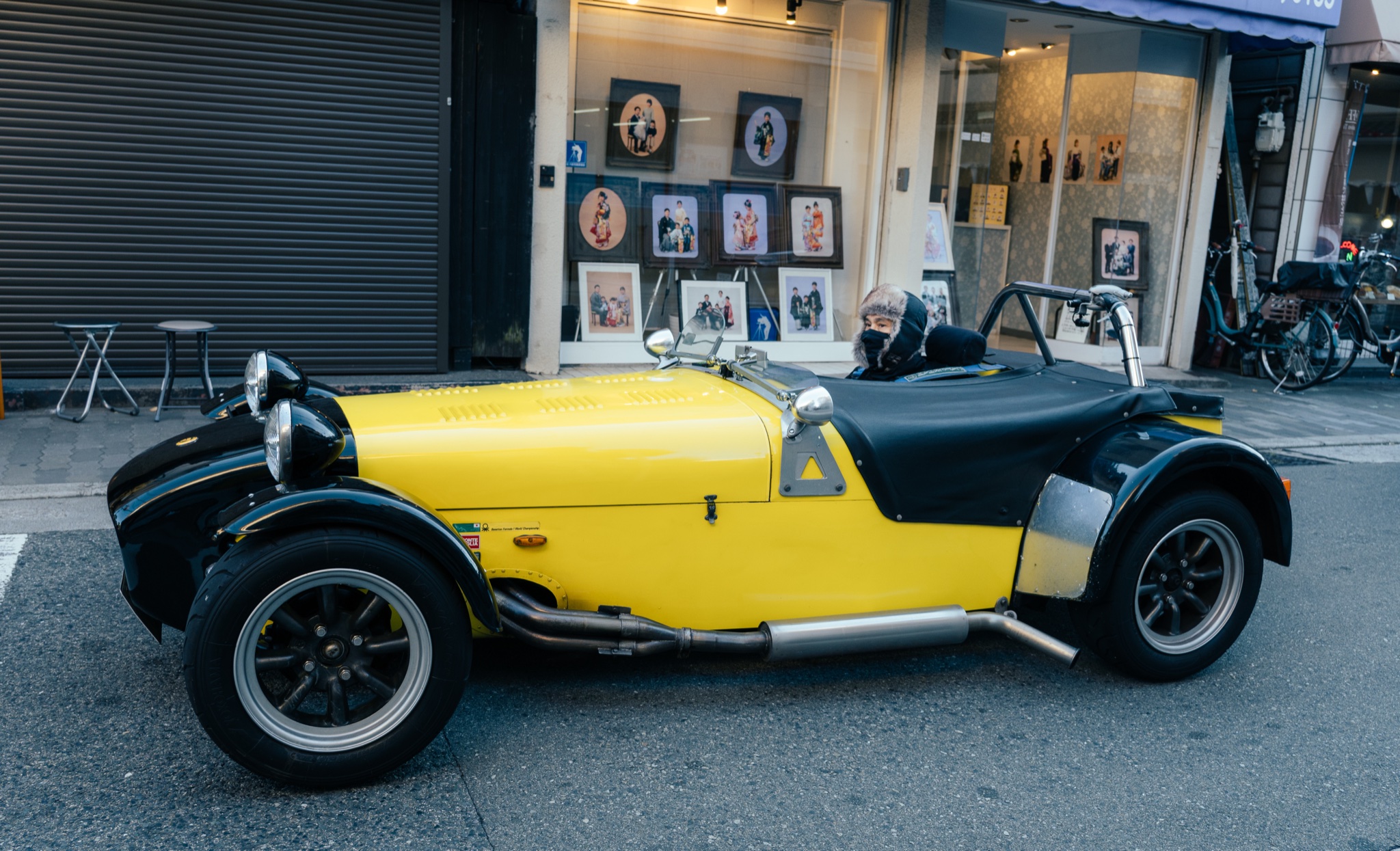 Vintage roadster parked in an Osaka shopping street